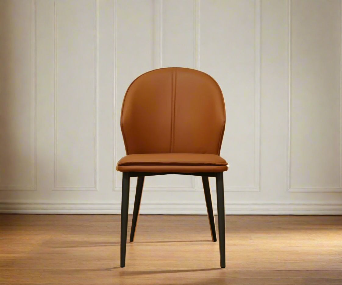046 leather curved accent chair in tan, front view against a panelled wall