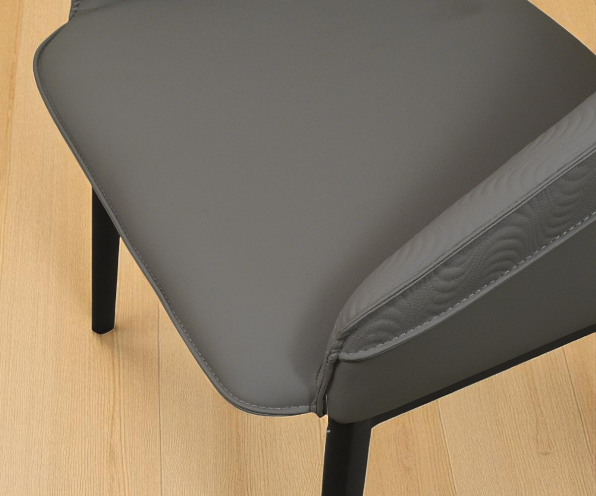 095 mid-century dining chair in grey, angled view on a wood floor