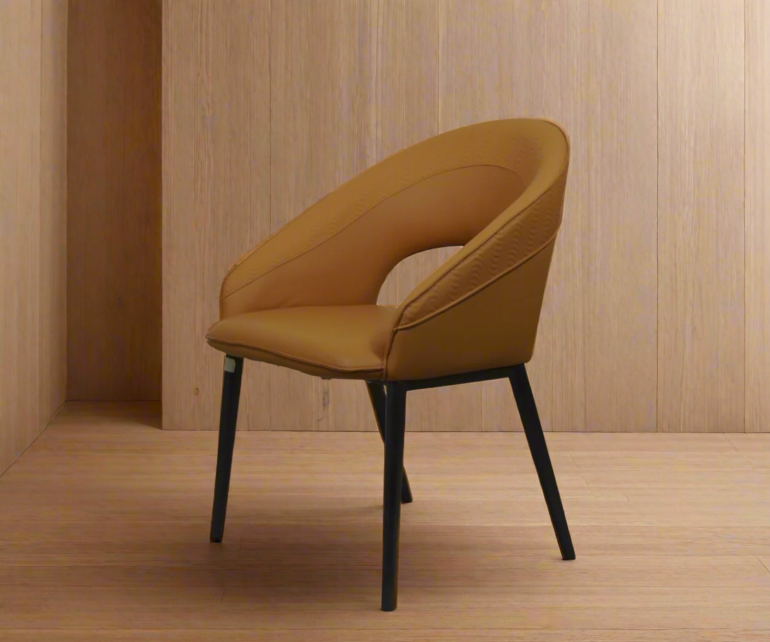 095 tan leather silhouette chair, angled view against a wood-panelled wall
