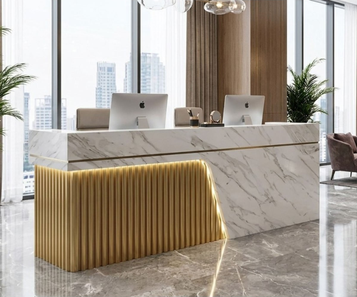 1029 gold marble reception desk with fluted gold front in a bright lobby