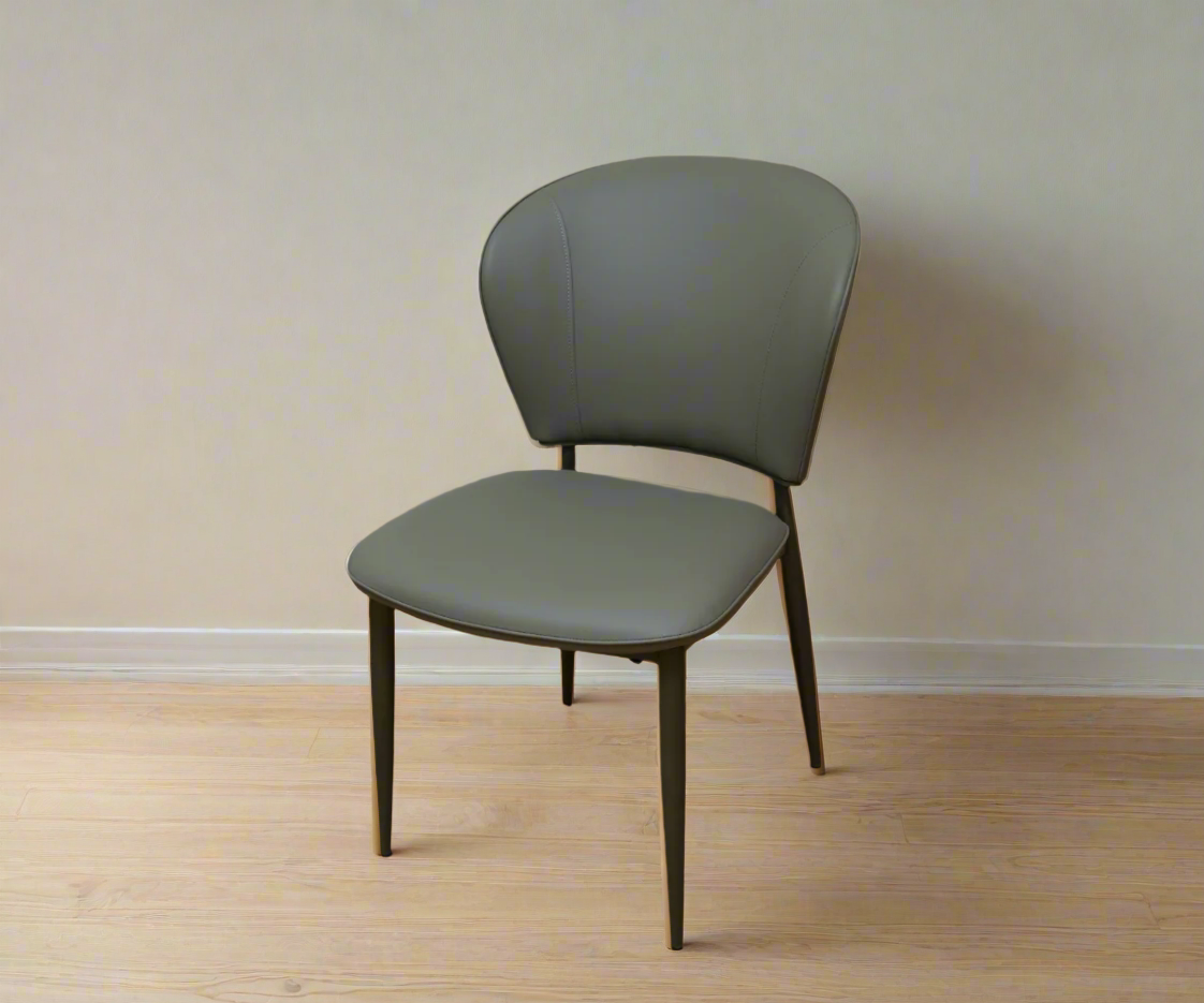 119 contemporary designer armchair, angled view on a wood floor