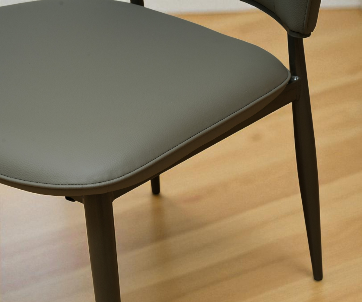 119 contemporary designer armchair, angled view on a wood floor