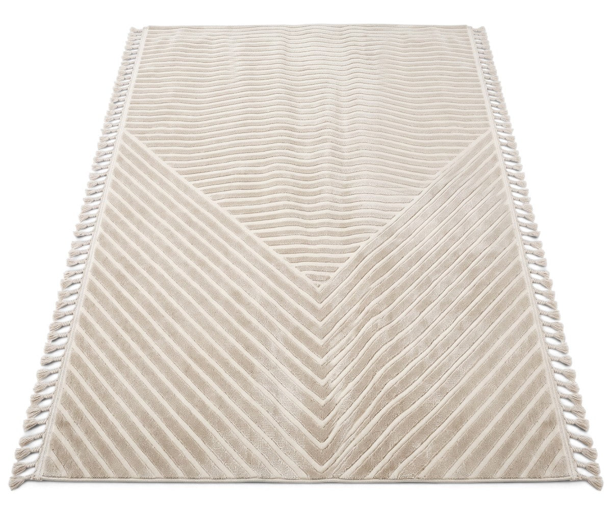 A rectangular cream-colored area rug with a textured chevron and diagonal striped pattern, finished with fringe on the sides, shown against a plain white background.