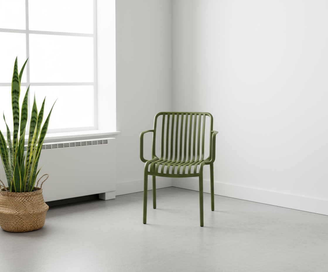 7102 ribbed designer patio chair in olive, in a white room beside a snake plant