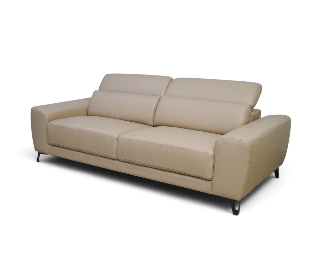 Contemporary beige leather sofa with tilting headrests shown at an angle