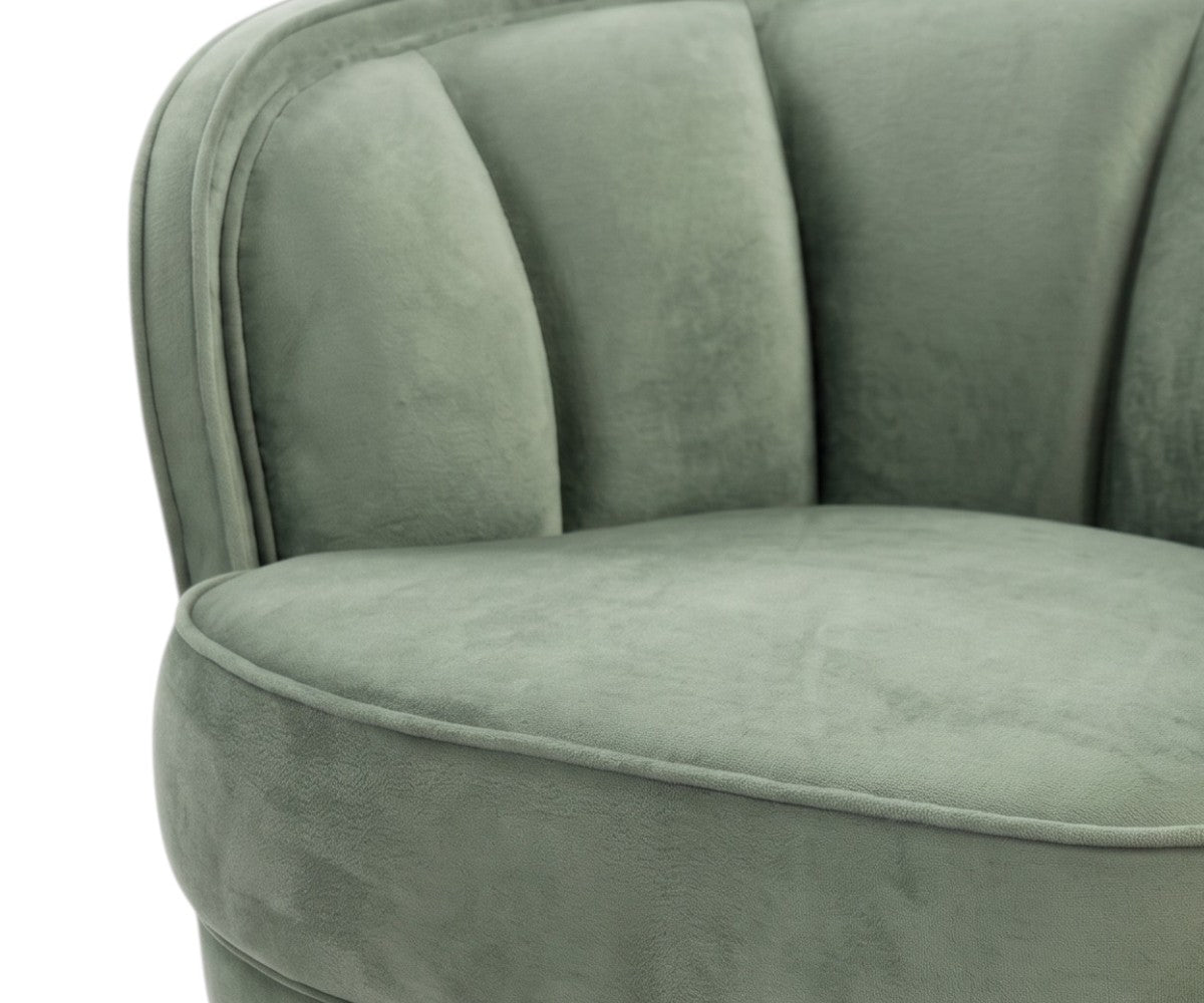 Green velvet barrel armchair with curved arms and slim black tapered legs