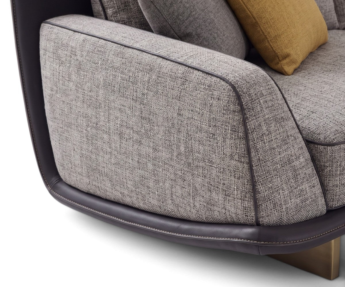 Grey fabric sofa set with matching wrap-around armchairs and ochre pillows