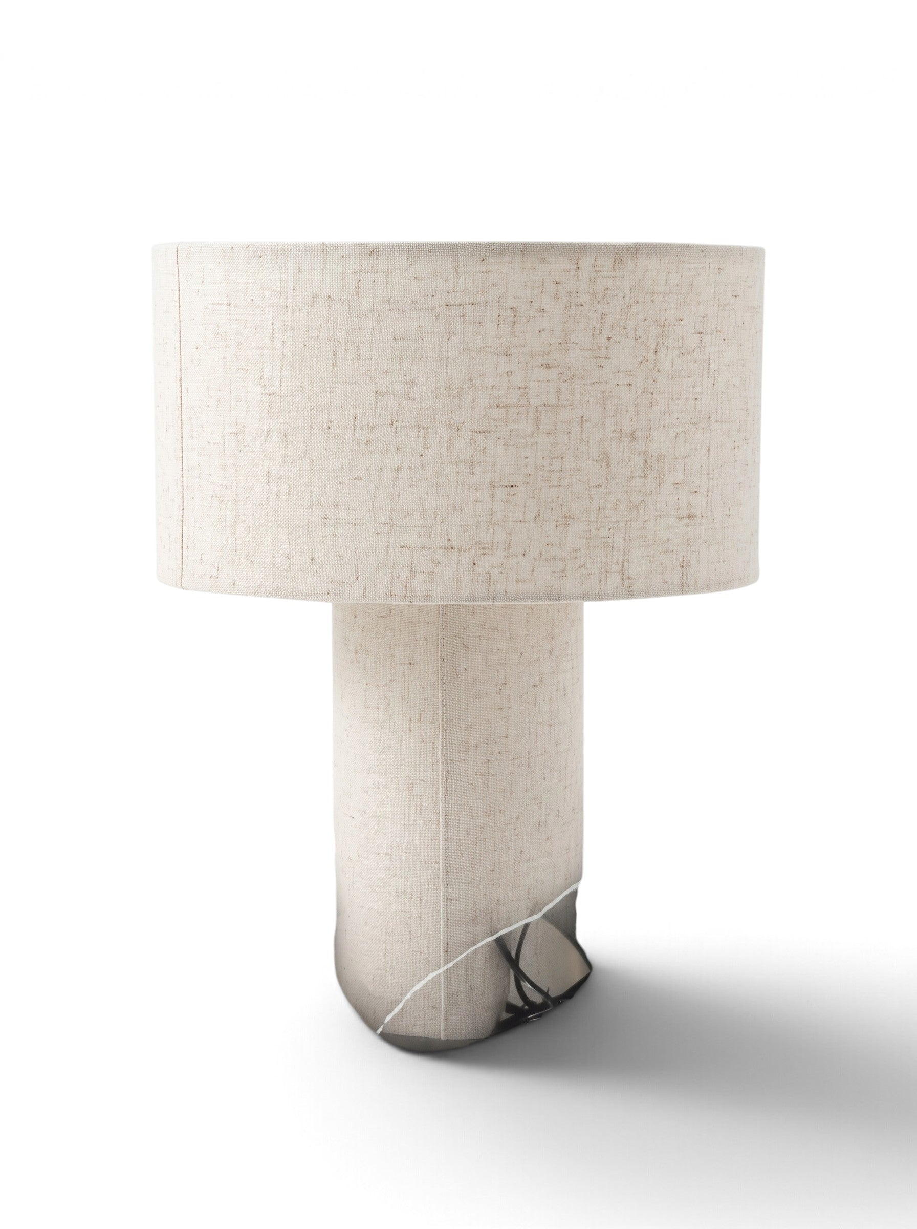 Beige drum shade table lamp styled in a luxurious, well-lit living room interior