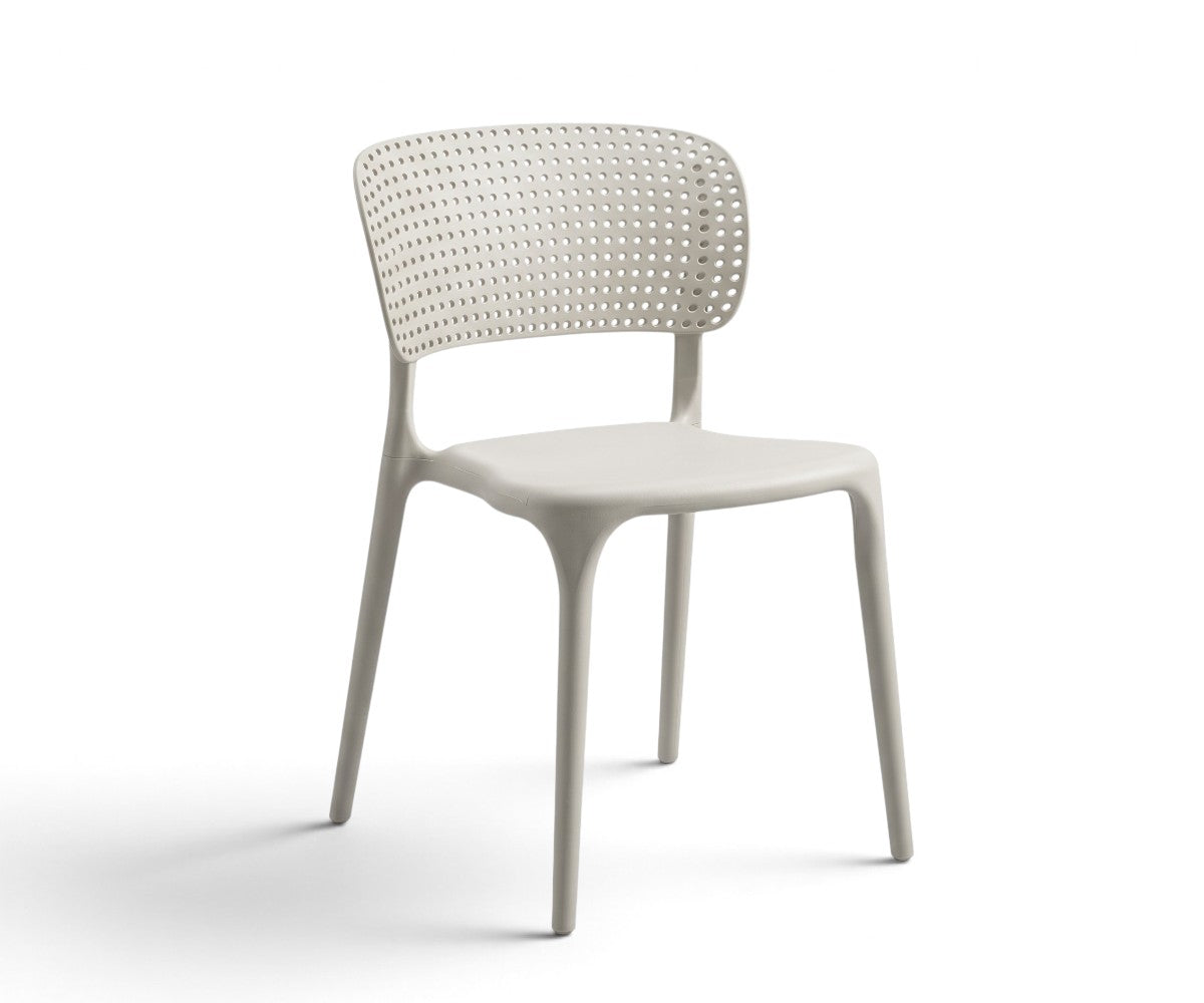 Light grey armless dining chair with a perforated curved backrest and four tapered legs.