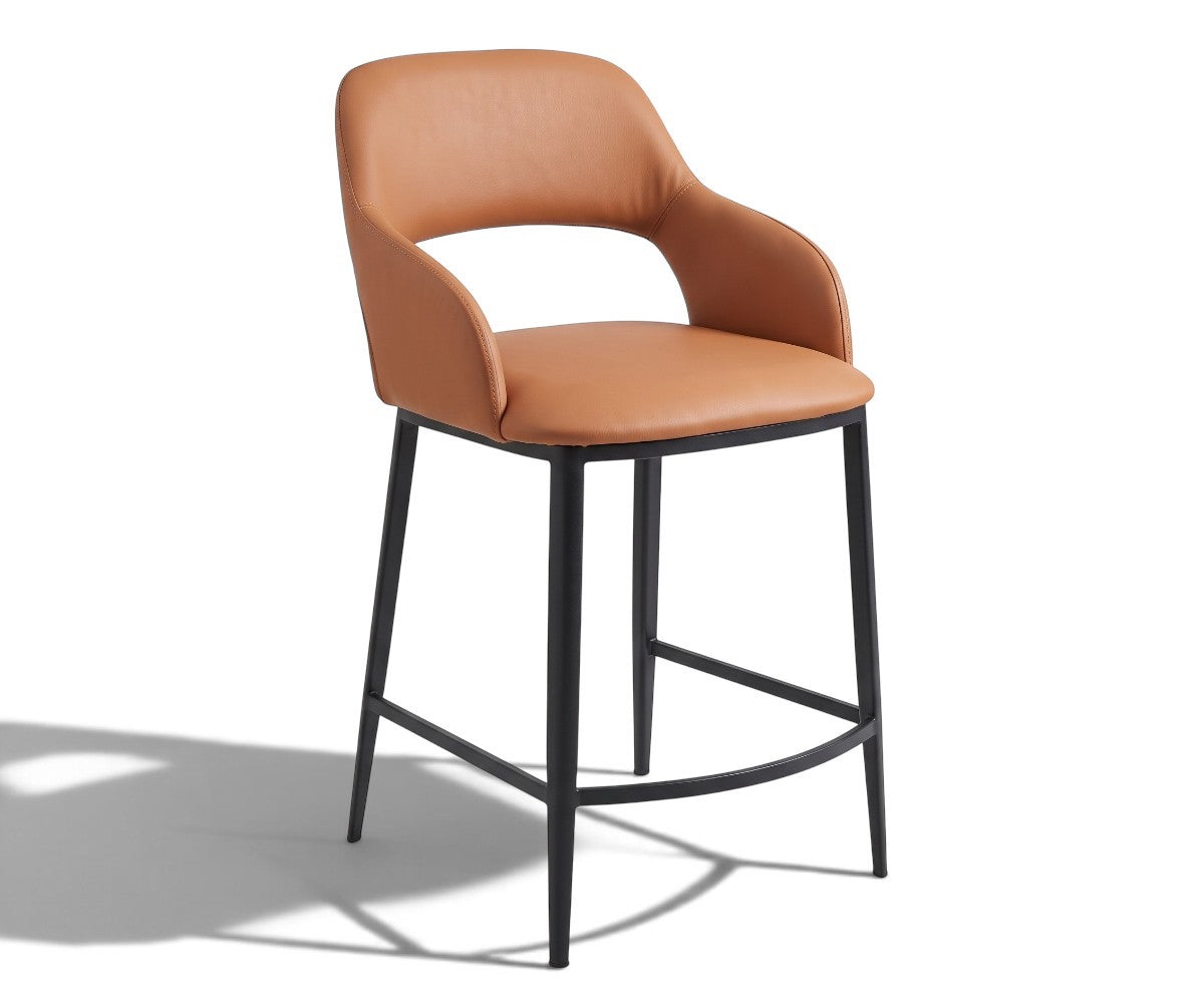 A modern counter-height bar stool with a curved, upholstered backrest and seat in a warm tan leather, supported by a slim black metal frame with a footrest, shown on a white background with a soft shadow.