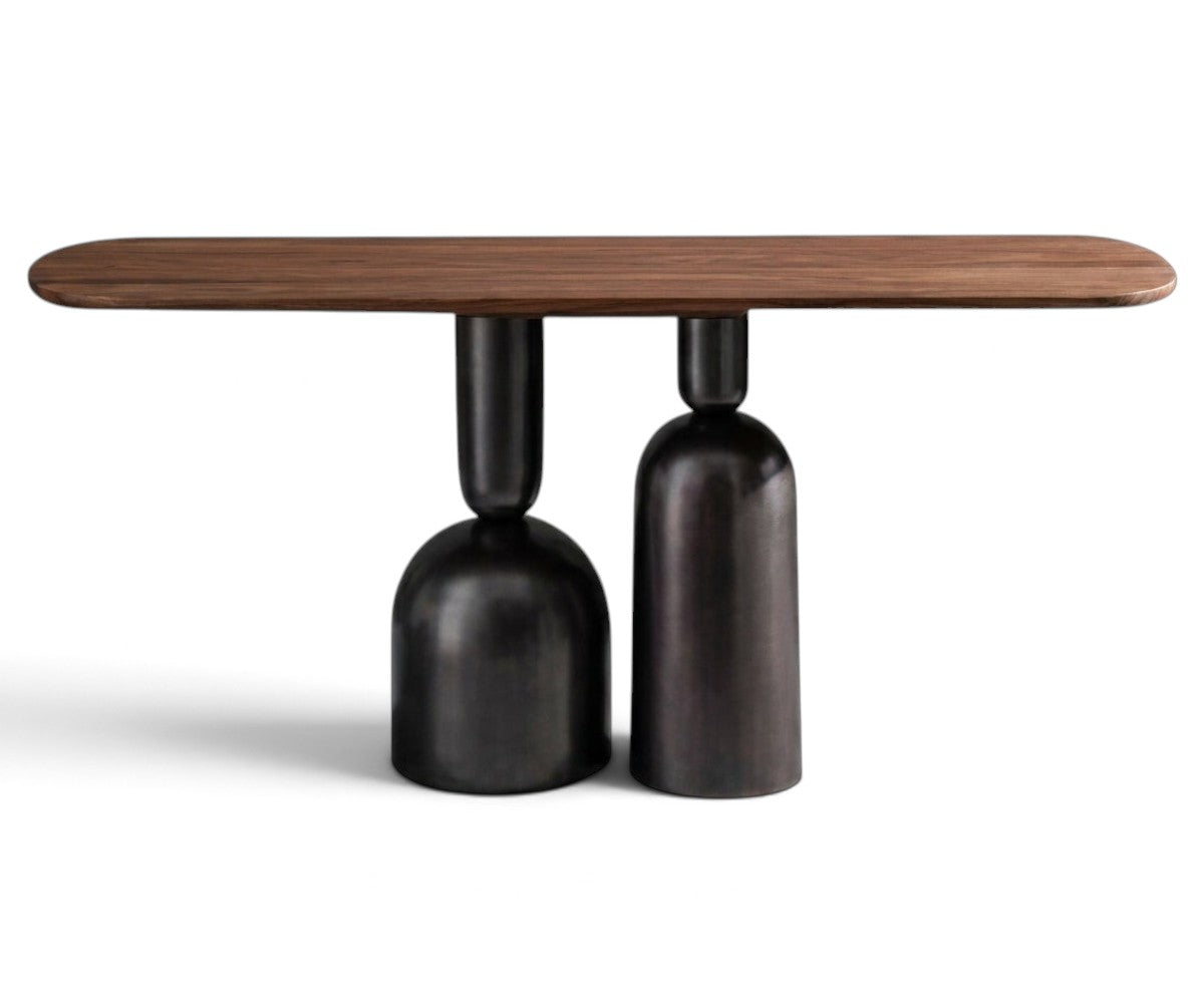 Sculptural walnut console table with two dark patina cast metal bases