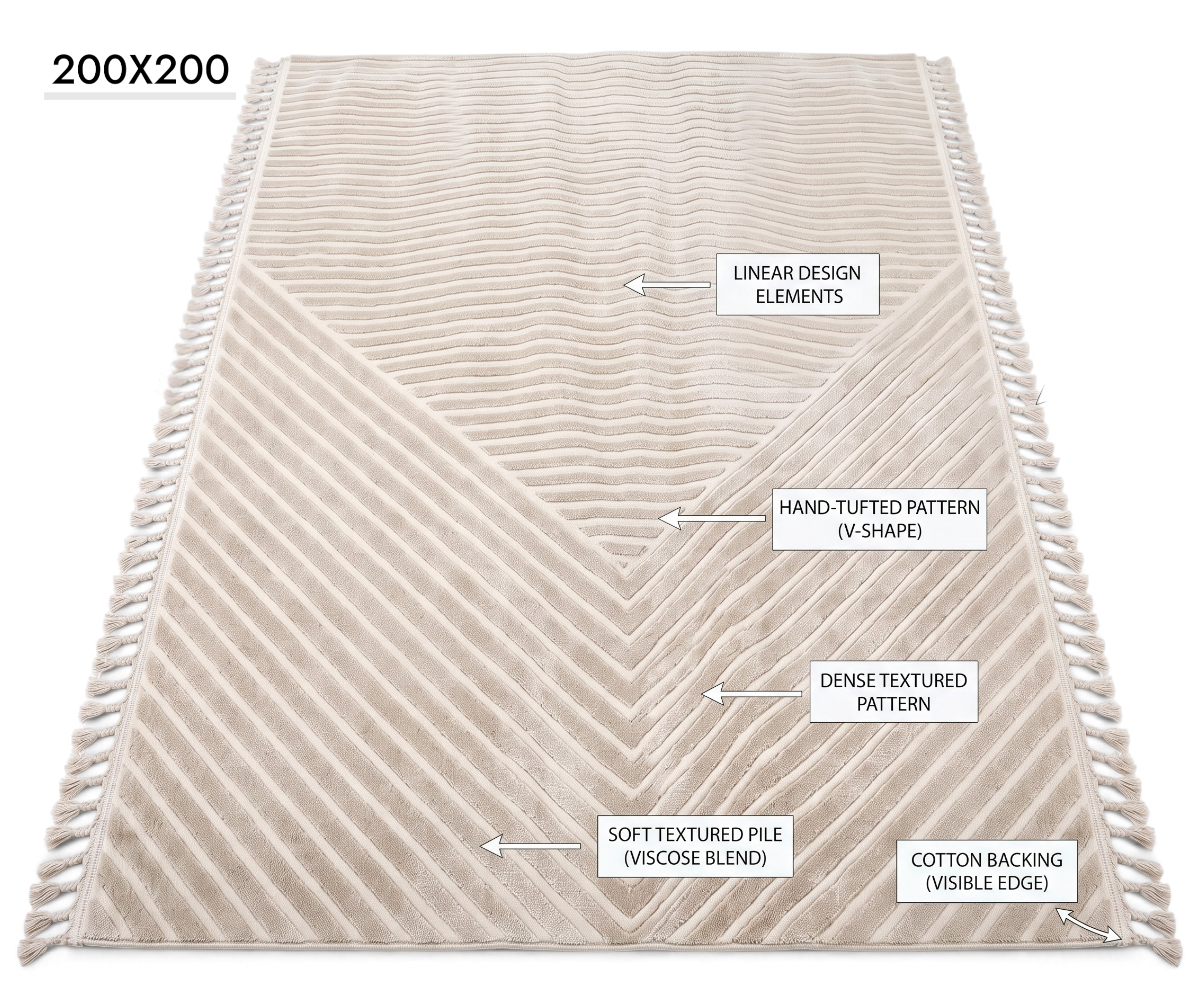 A rectangular cream-colored area rug with a textured chevron and diagonal striped pattern, finished with fringe on the sides, shown against a plain white background.