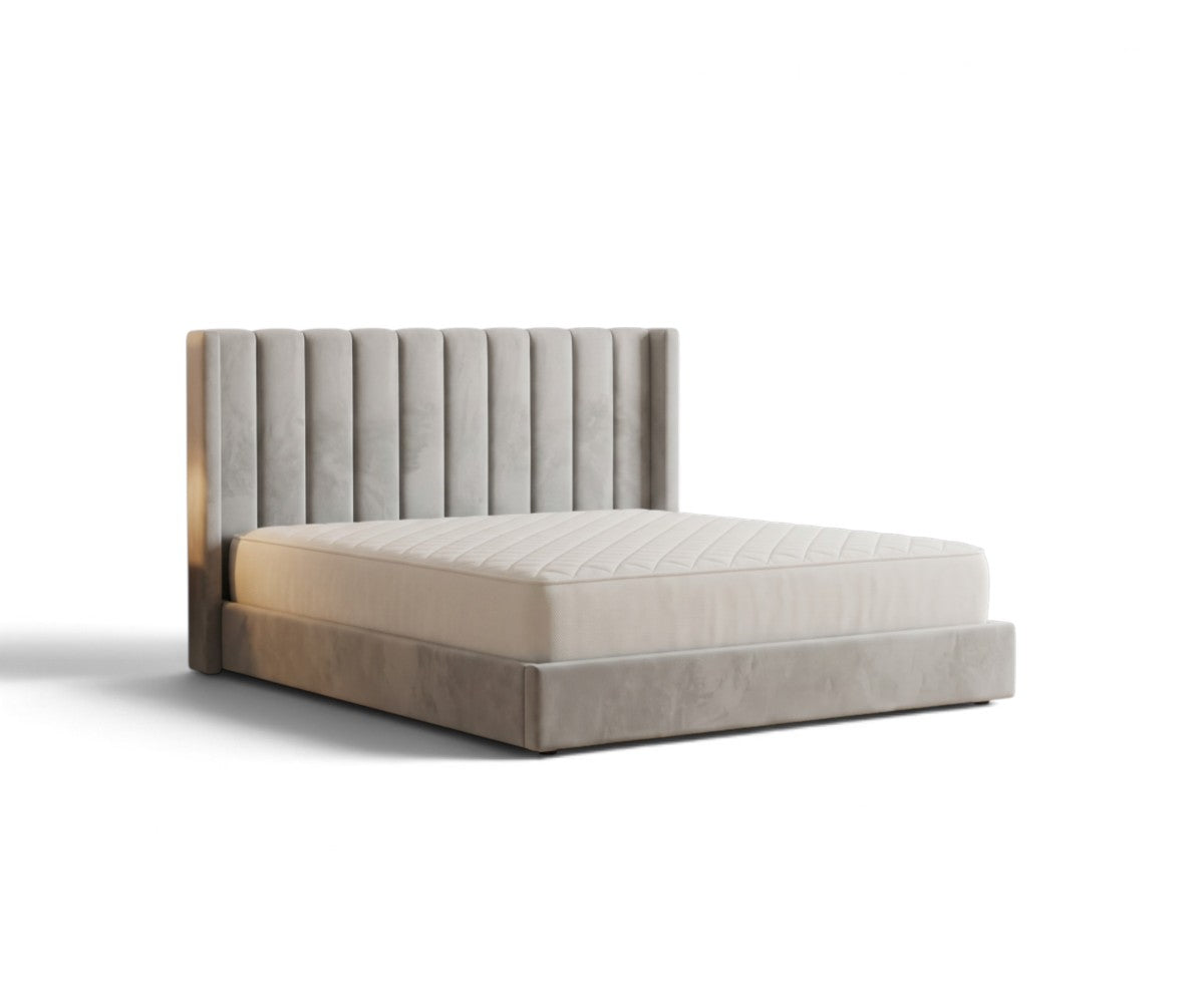 Velvet platform bed with channel-tufted wingback headboard and brass edge trim