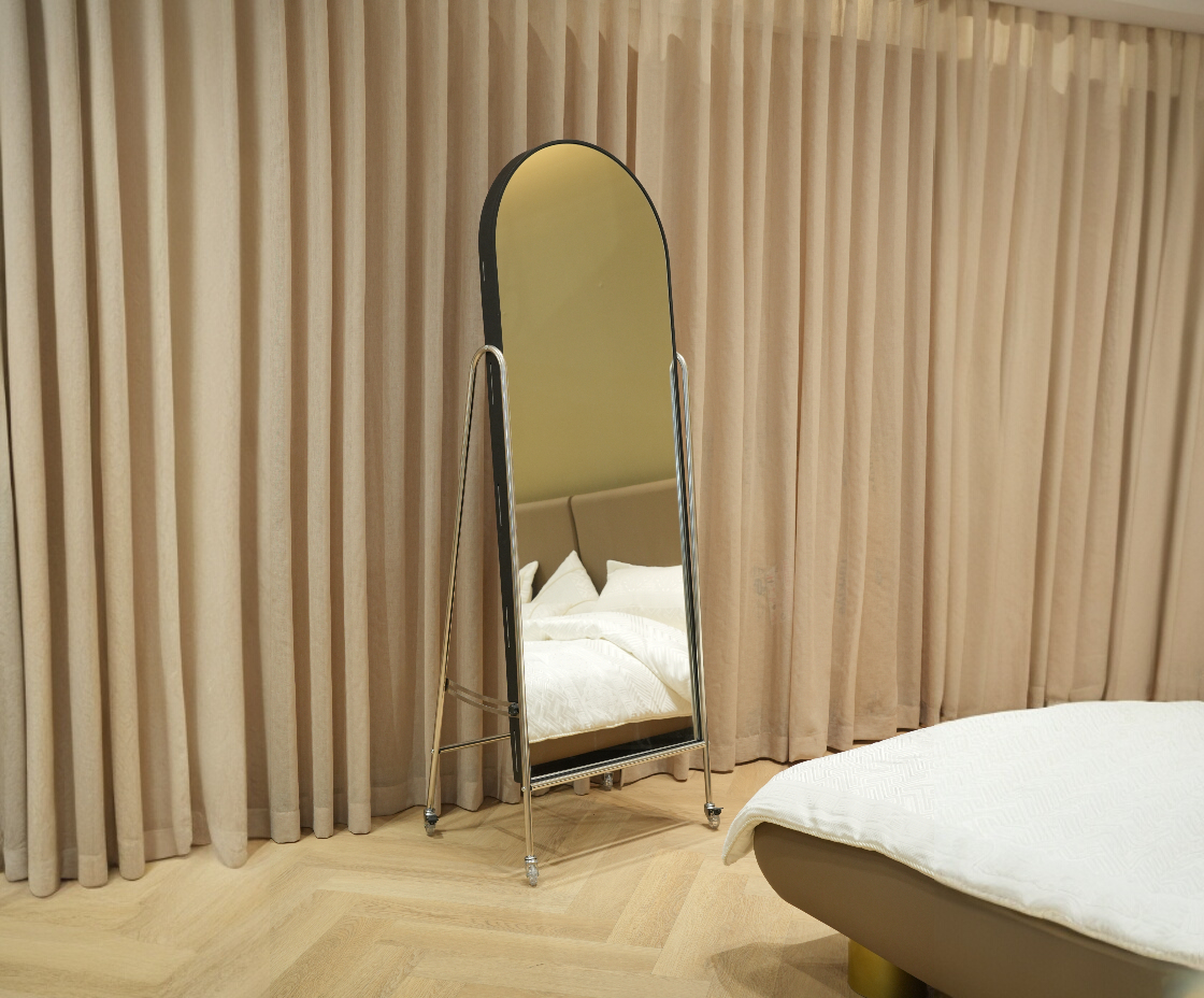 A-1 storage standing mirror in a curtained bedroom beside a chaise