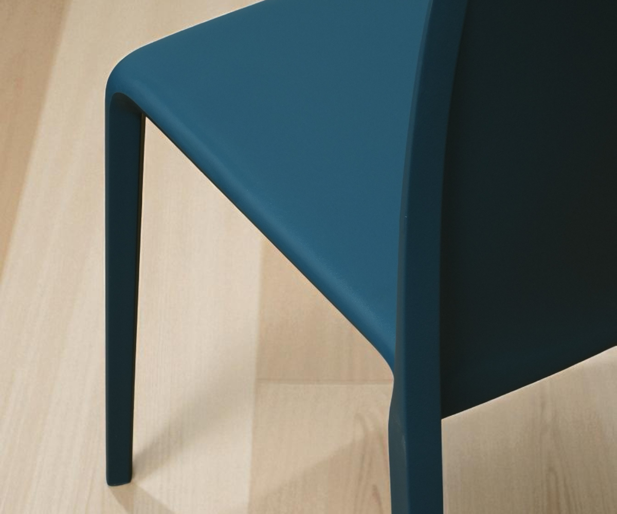 A650 ocean blue minimalist designer chair, angled view against a pale wall