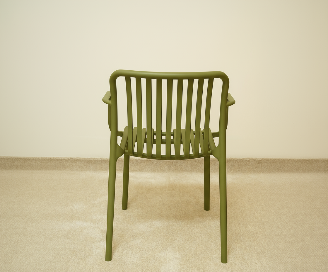 A654 moss green architectural outdoor chair in a bright room beside a sofa