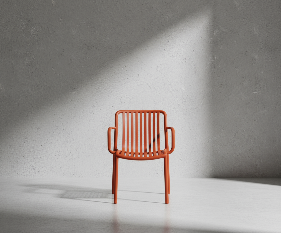 A654 sunset ribbed designer patio chair in rust, angled view in a bright room
