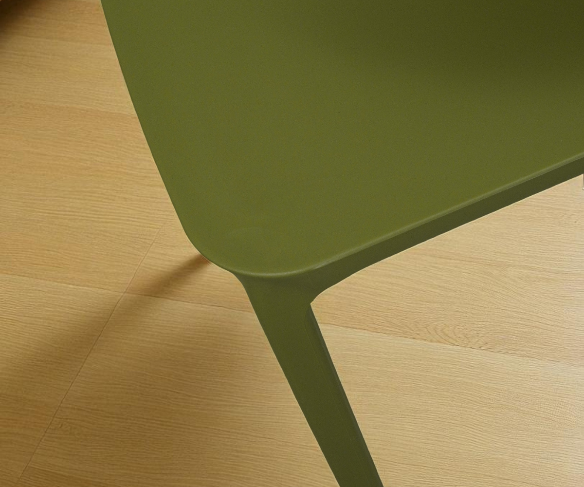 A669 green minimalist designer chair, angled view in raking light