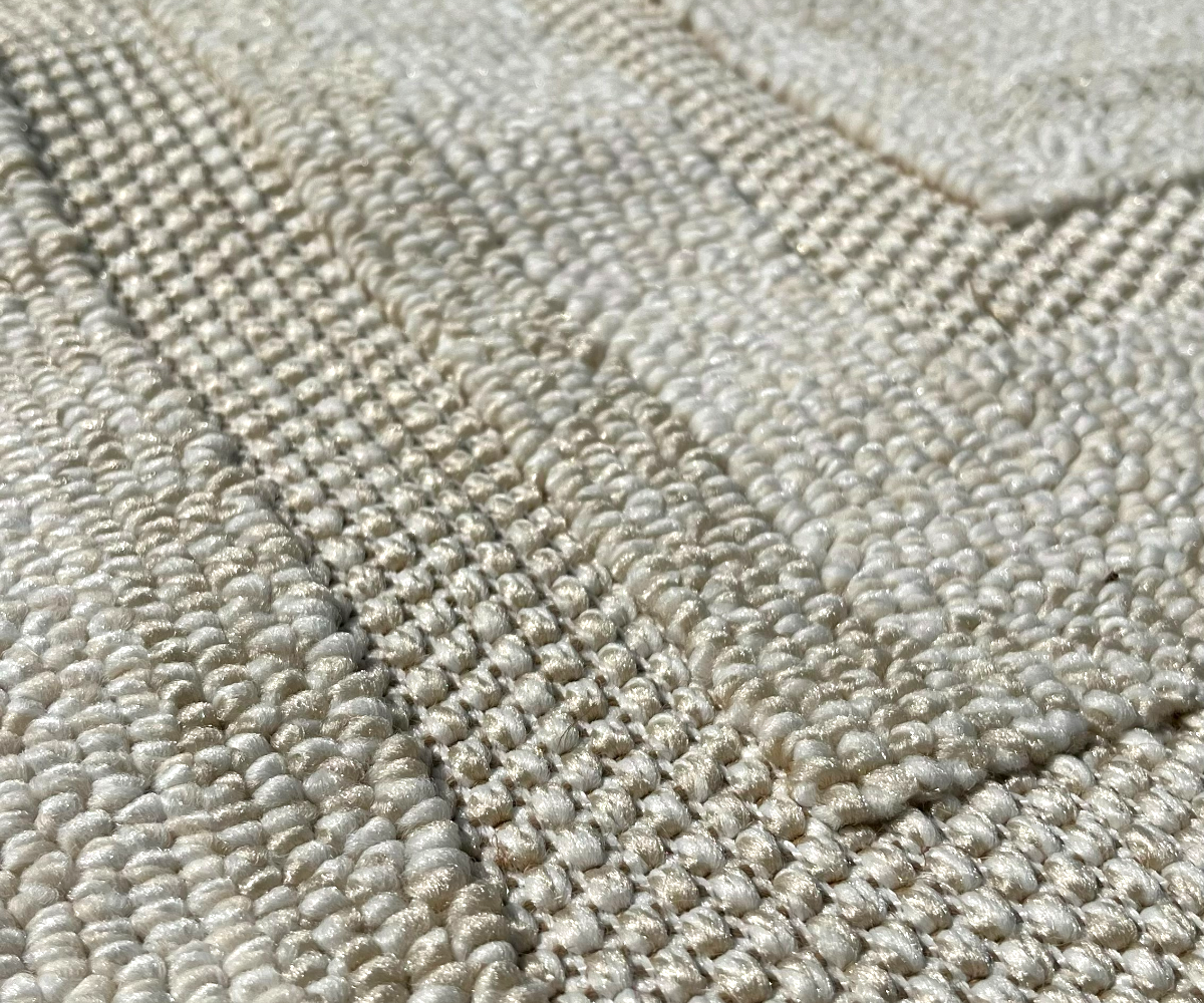 ALABASTER frame bordered rug in cream, 200x300 cm, corner detail on a marble floor