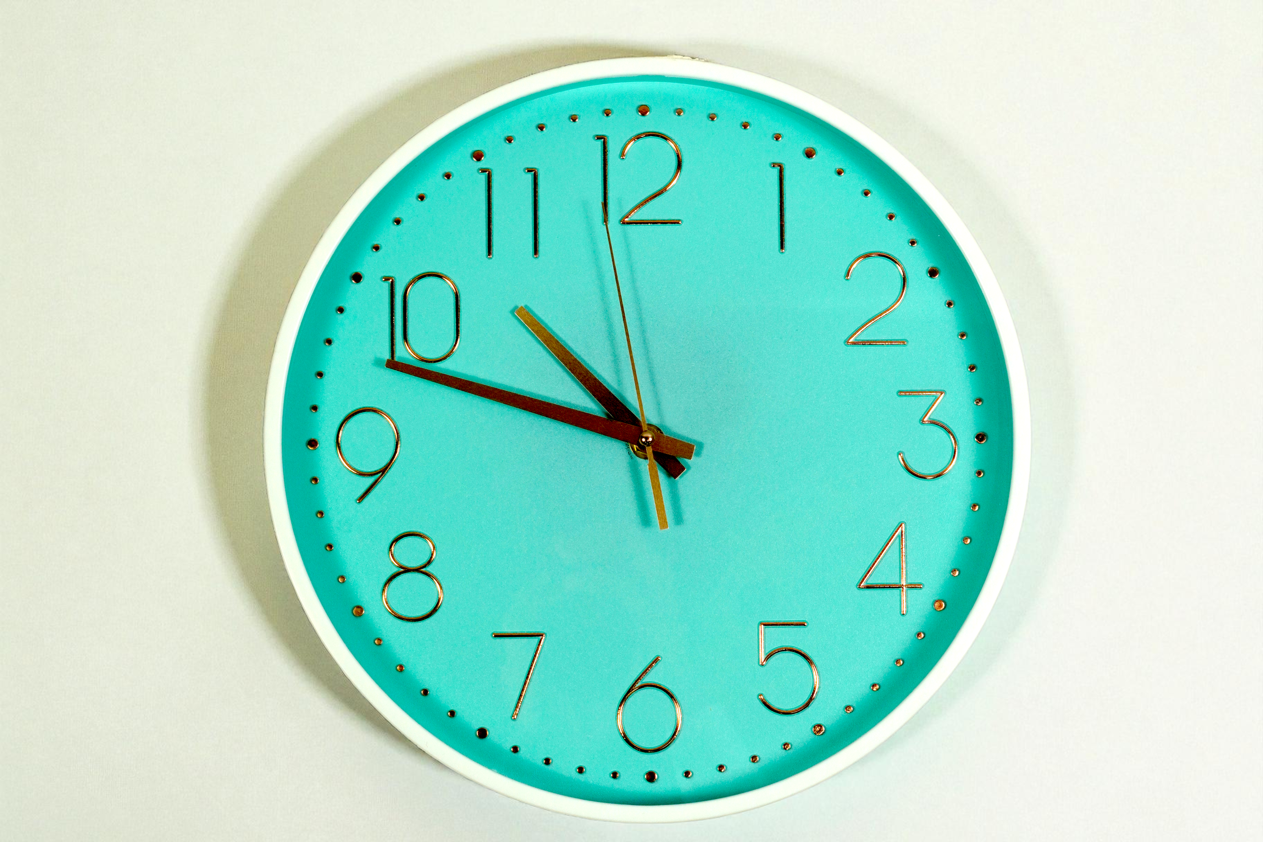 Aqua gold numeral wall clock with a white rim and red second hand