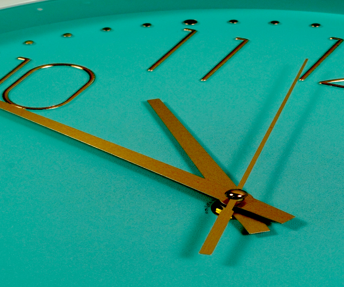Aqua gold numeral wall clock with a white rim and red second hand