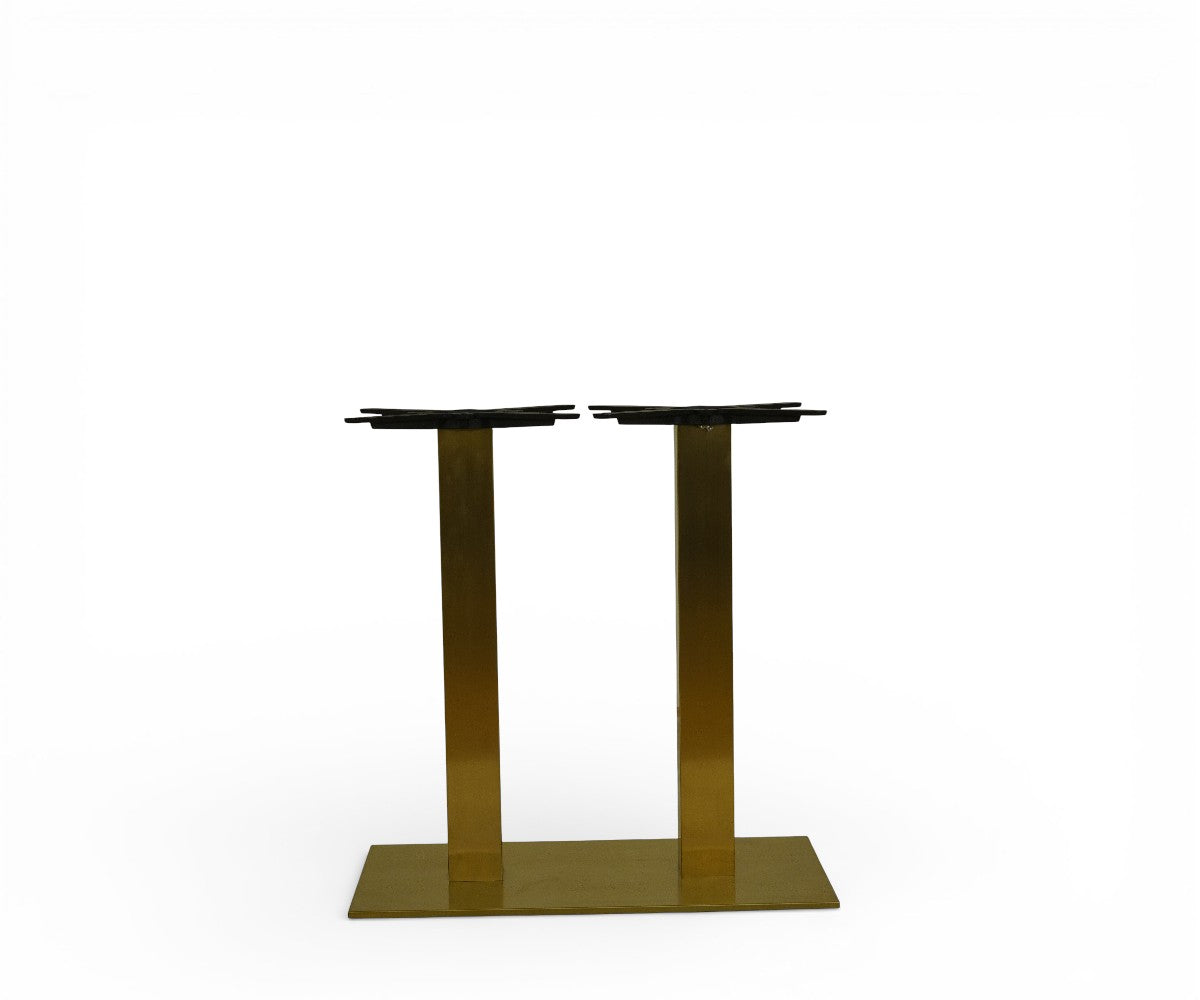 AURELIUS brushed gold double pedestal table base in a panelled restaurant