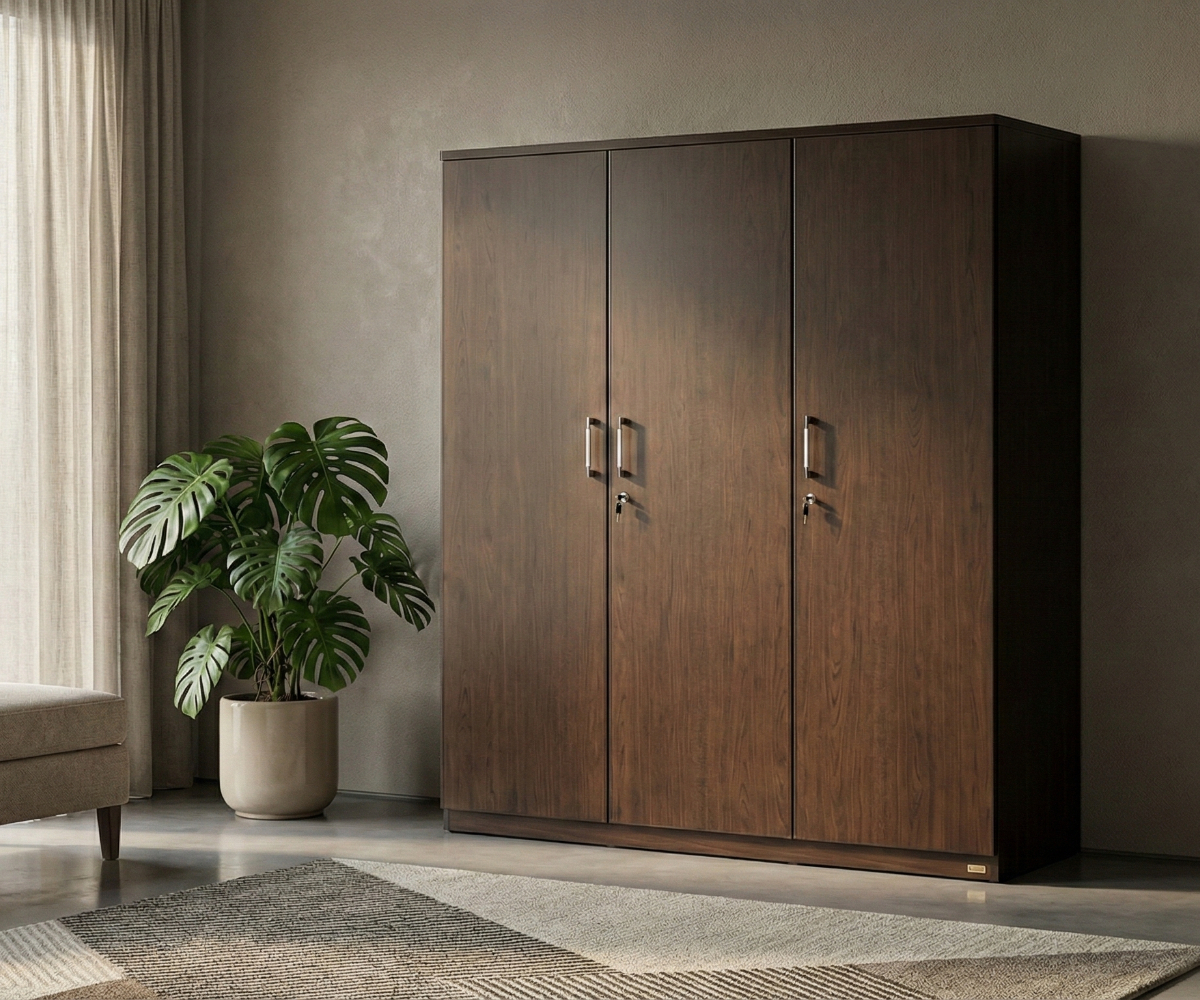 AURELIUS triple-door walnut wardrobe in a dark bedroom beside a monstera