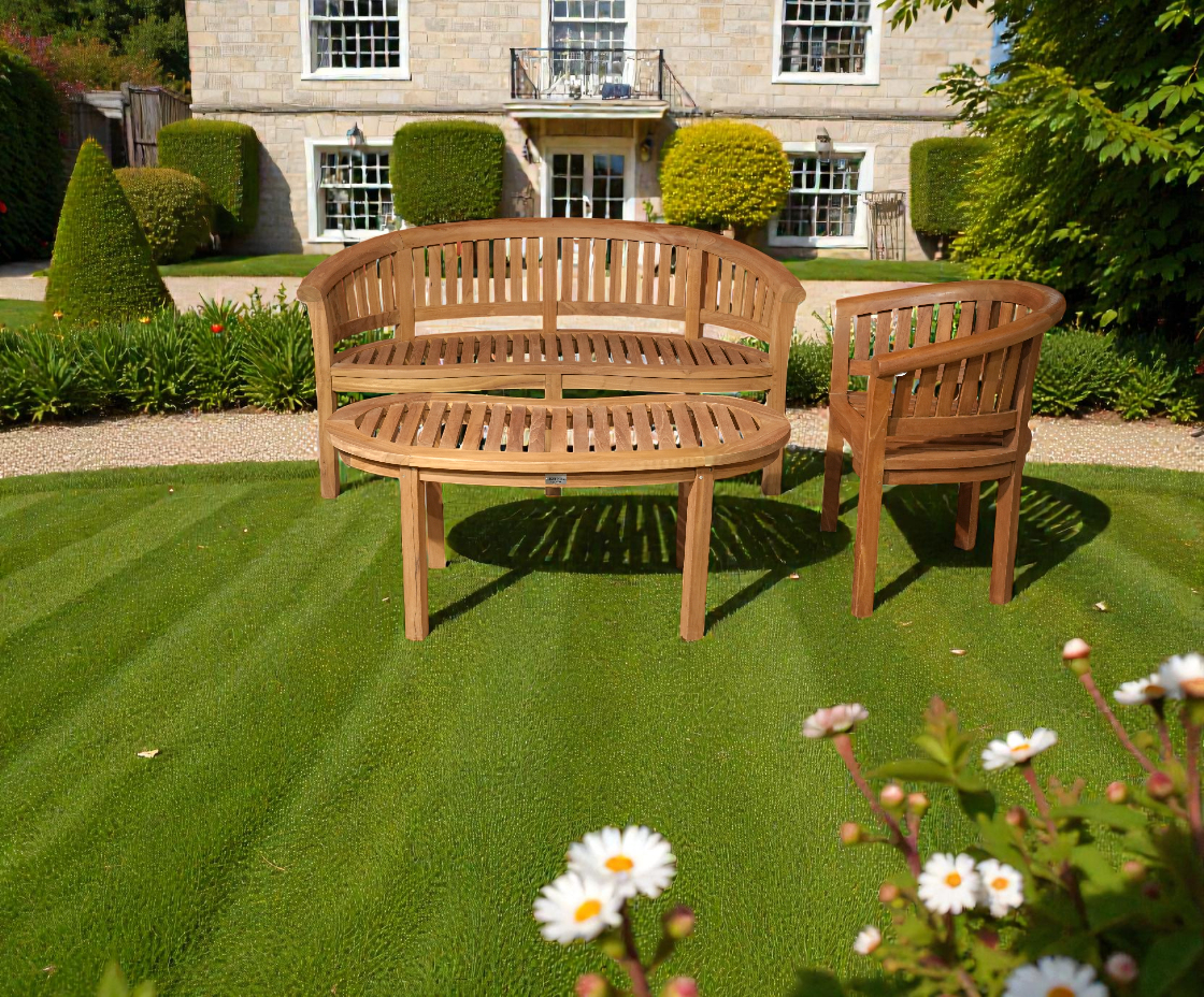Banana bench set, curved teak bench and armchair on a manicured lawn