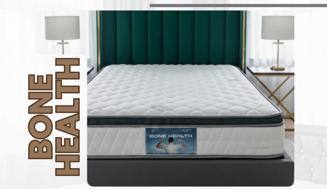 Bone Health pillow-top mattress with a charcoal border, in a bedroom with a green channel headboard