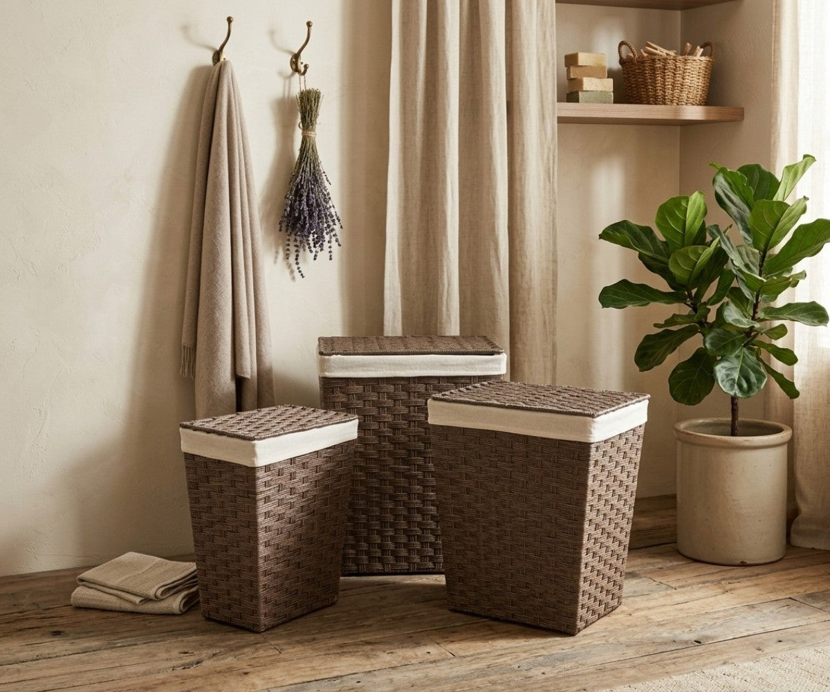Brown three-piece laundry bag set with lids and cream lining styled in a luxurious, well-lit modern dressing room
