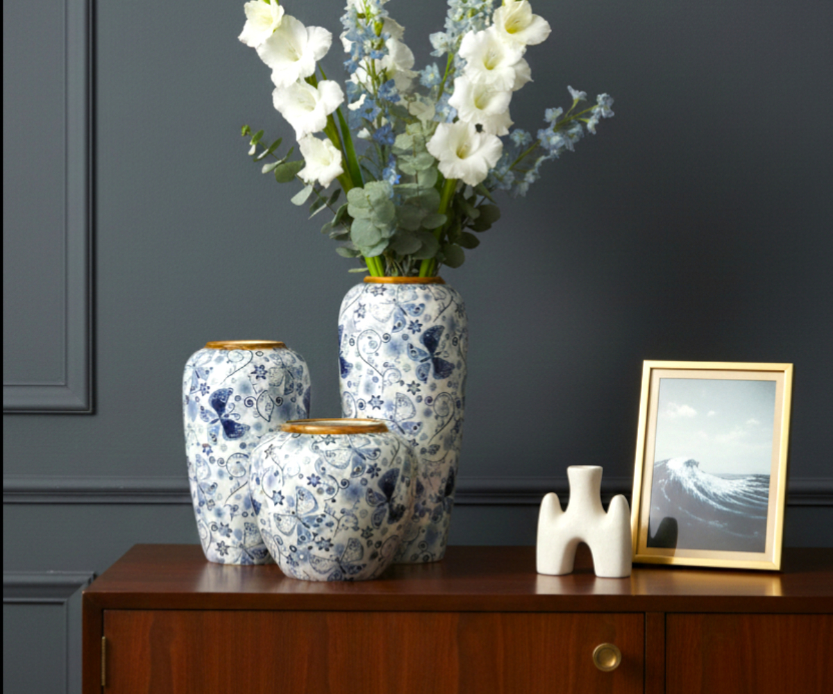 Butterfly pattern ceramic vase A1035, three vases styled on a walnut sideboard