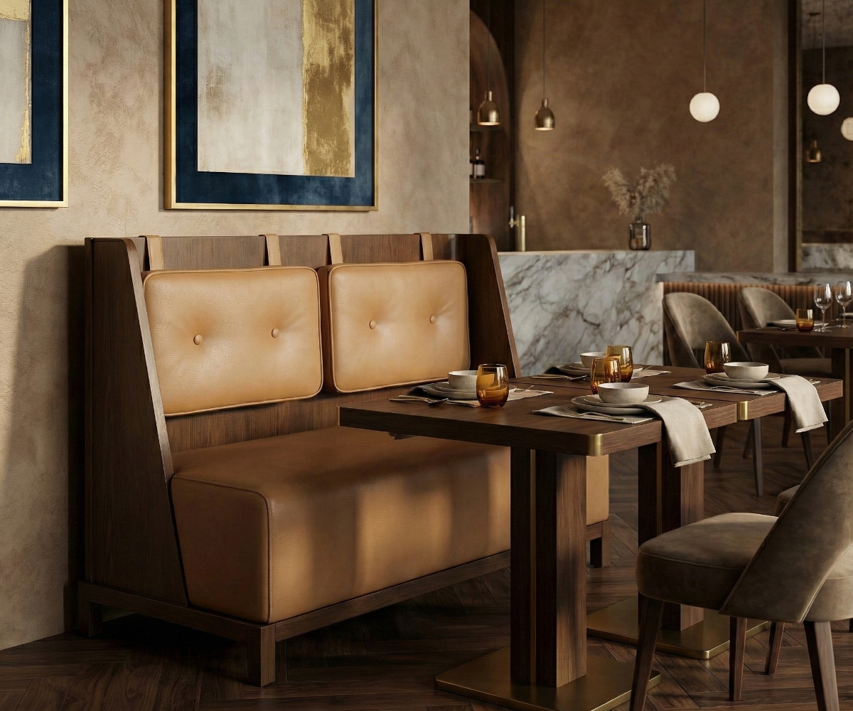 Caramel tufted privacy booth in a warm restaurant beside a marble wall