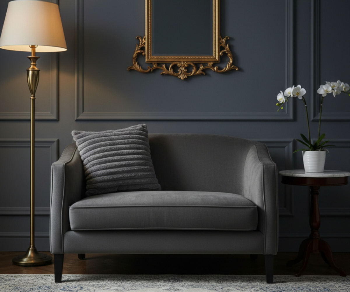 Charcoal ribbed velvet cushion cover on a grey sofa in a dark panelled room