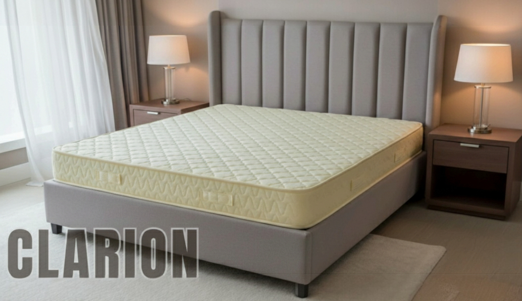 Clarion quilted mattress in cream, on a grey bed base with a grey channel headboard