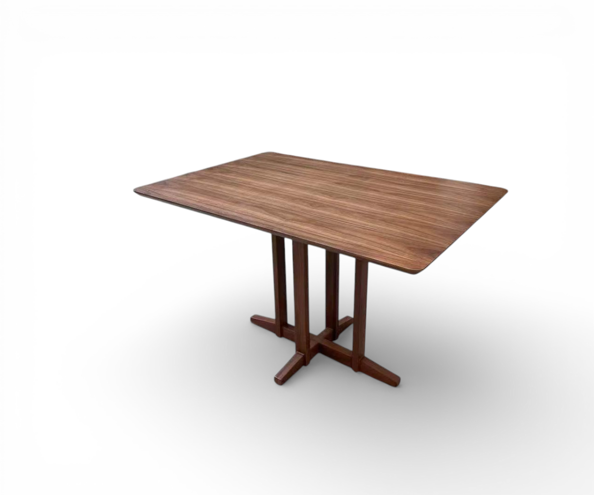 Cross base dining table in a city-view dining room with fluted panelling