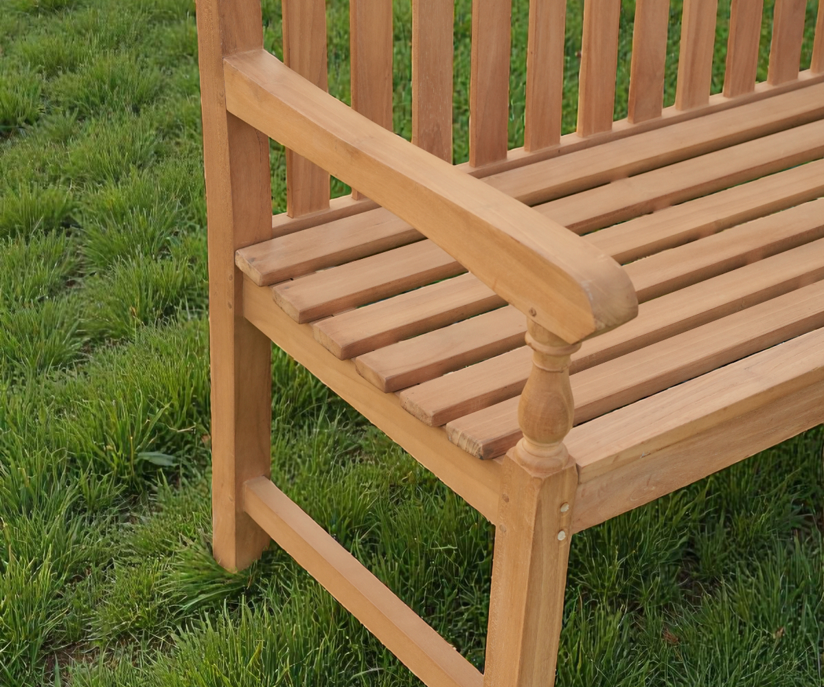 Crown garden bench, side view of a slatted teak bench beside a garden path