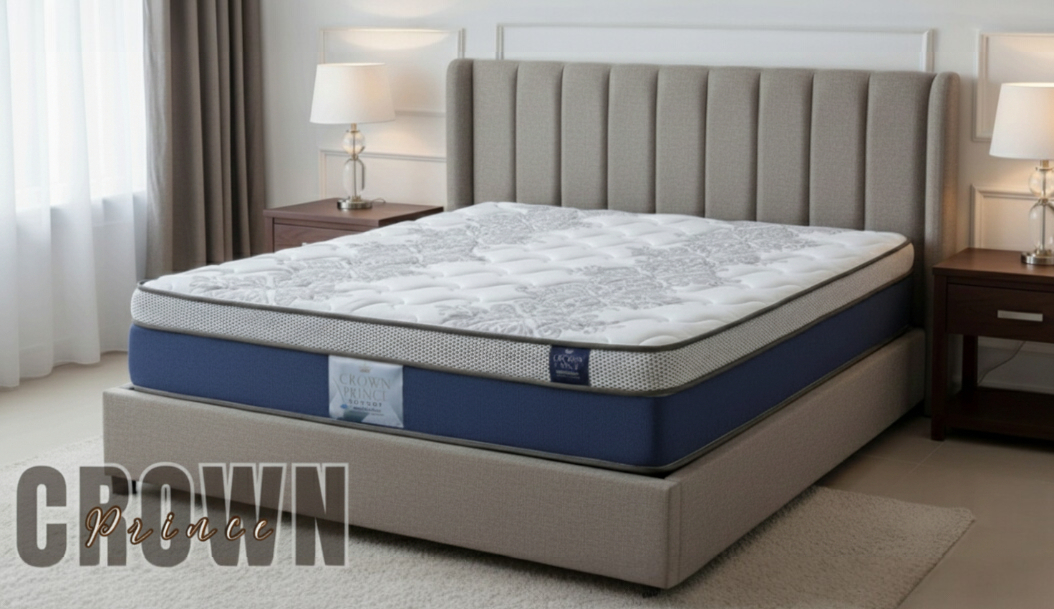 Crown pillow-top mattress with a navy blue border, on a grey base with a channel headboard