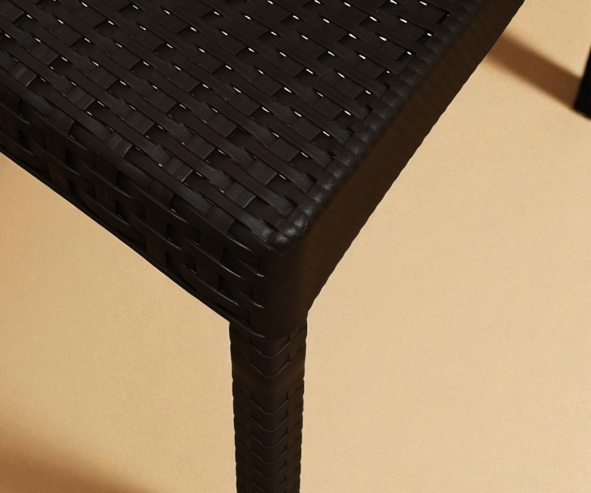 CT020 NERGISI woven minimalist chair in black, angled view on a wood floor