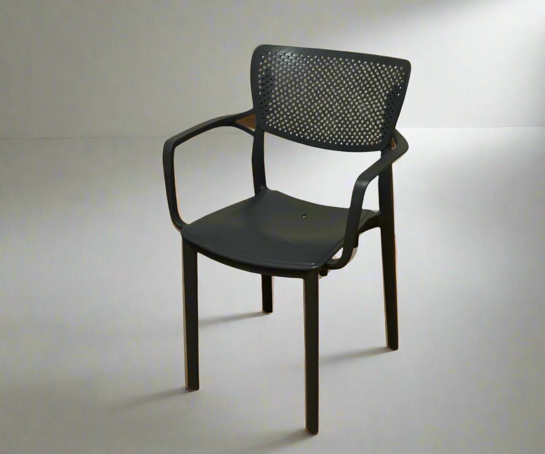 CT032 black perforated designer chair, angled view against a pale wall