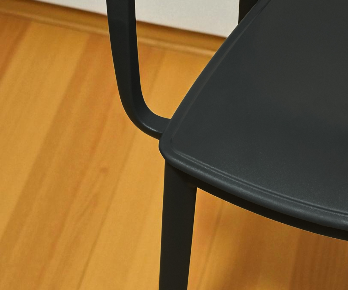 CT032 black perforated designer chair, angled view against a pale wall