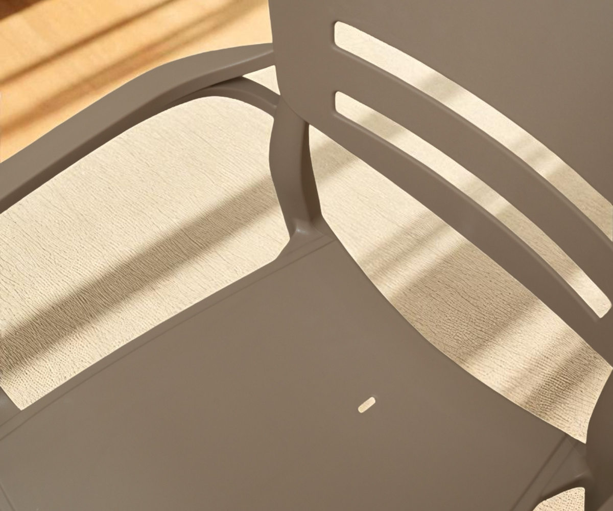 CT033 slotted taupe armchair, angled view against a pale wall