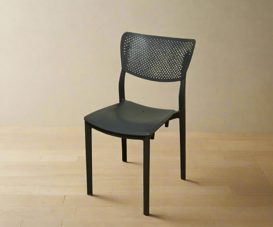 CT035 black perforated lifestyle chair, angled view on a light wood floor