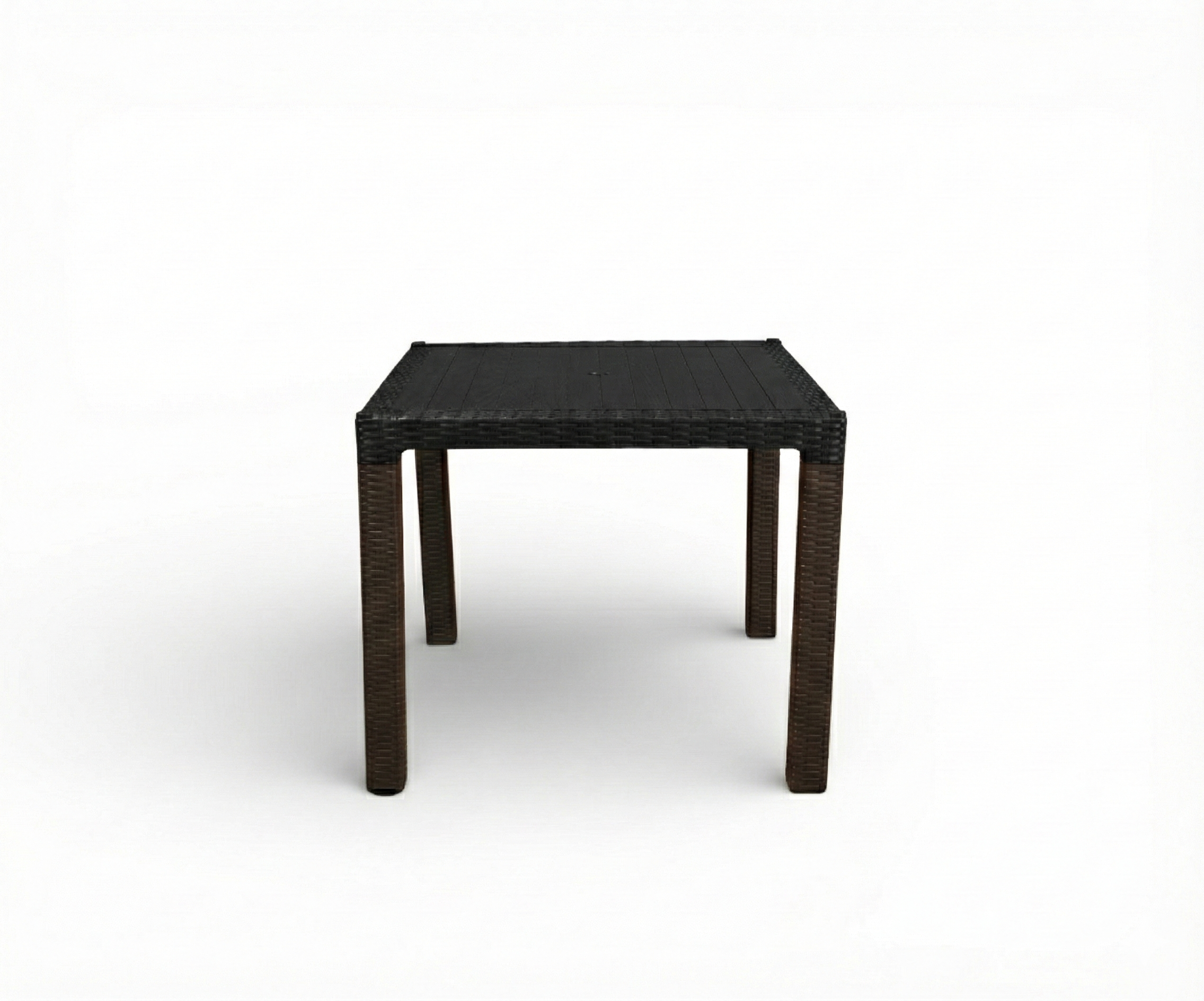 CT066 BEGONVIL rattan table, on a lit poolside terrace with dark loungers