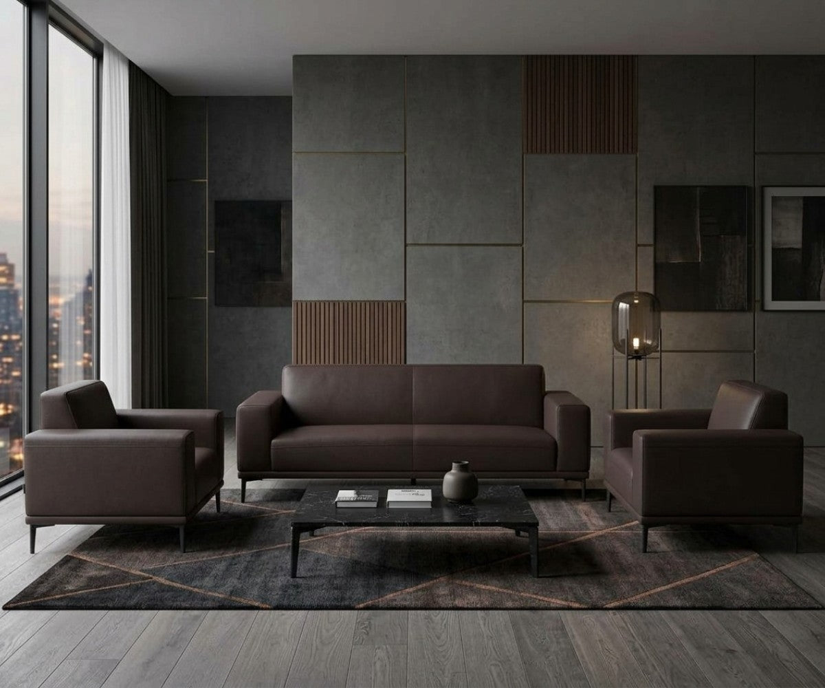 Dark brown three-piece sofa set with two matching armchairs in a luxurious, well-lit modern living room