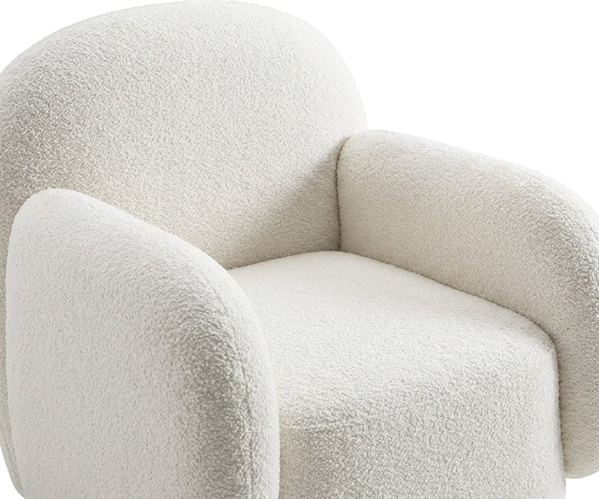 E06 cozy lounge armchair beside a fireplace in a warm living room