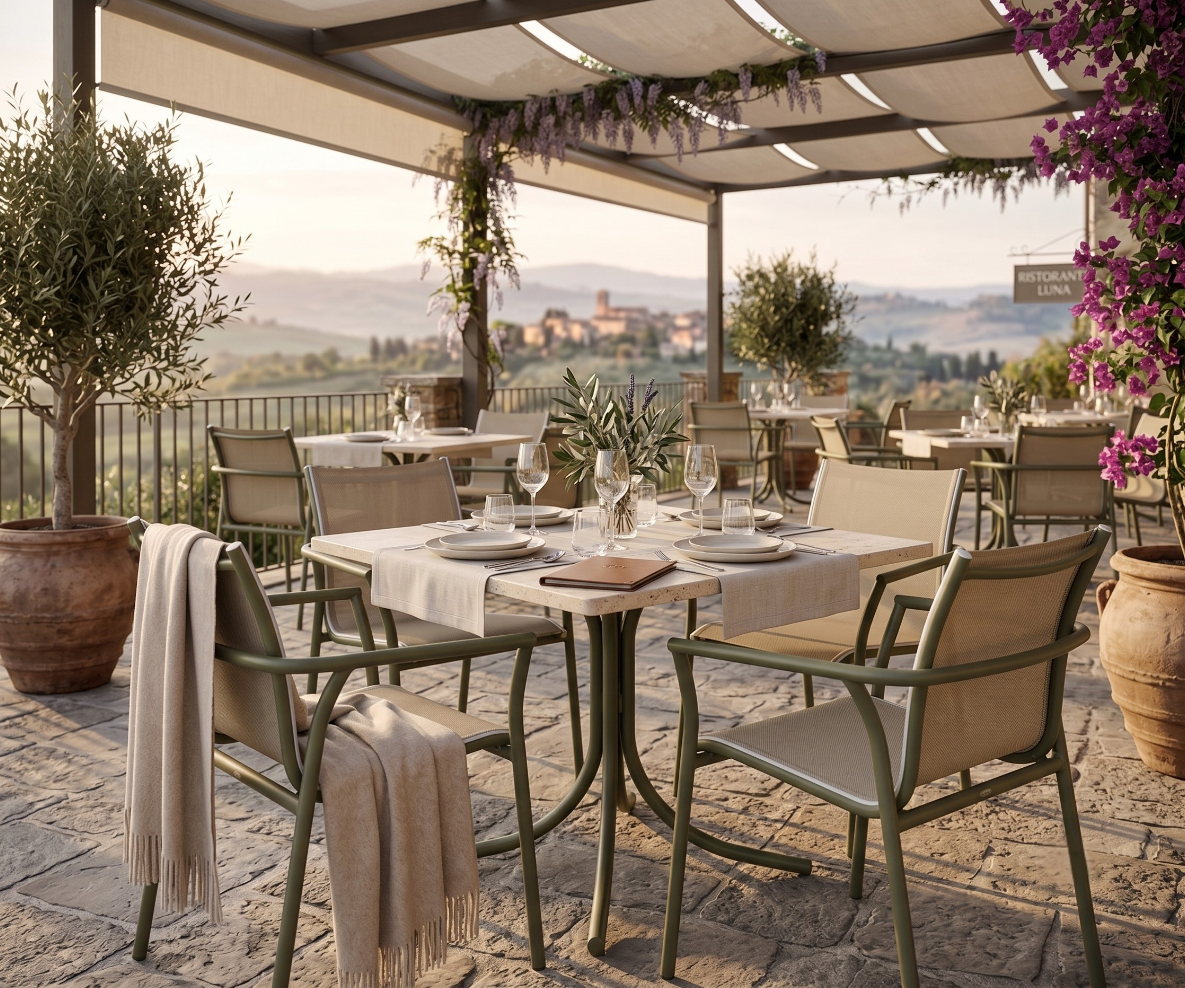 E31 garden chair, mesh-back chairs at a table on a Tuscan hillside terrace
