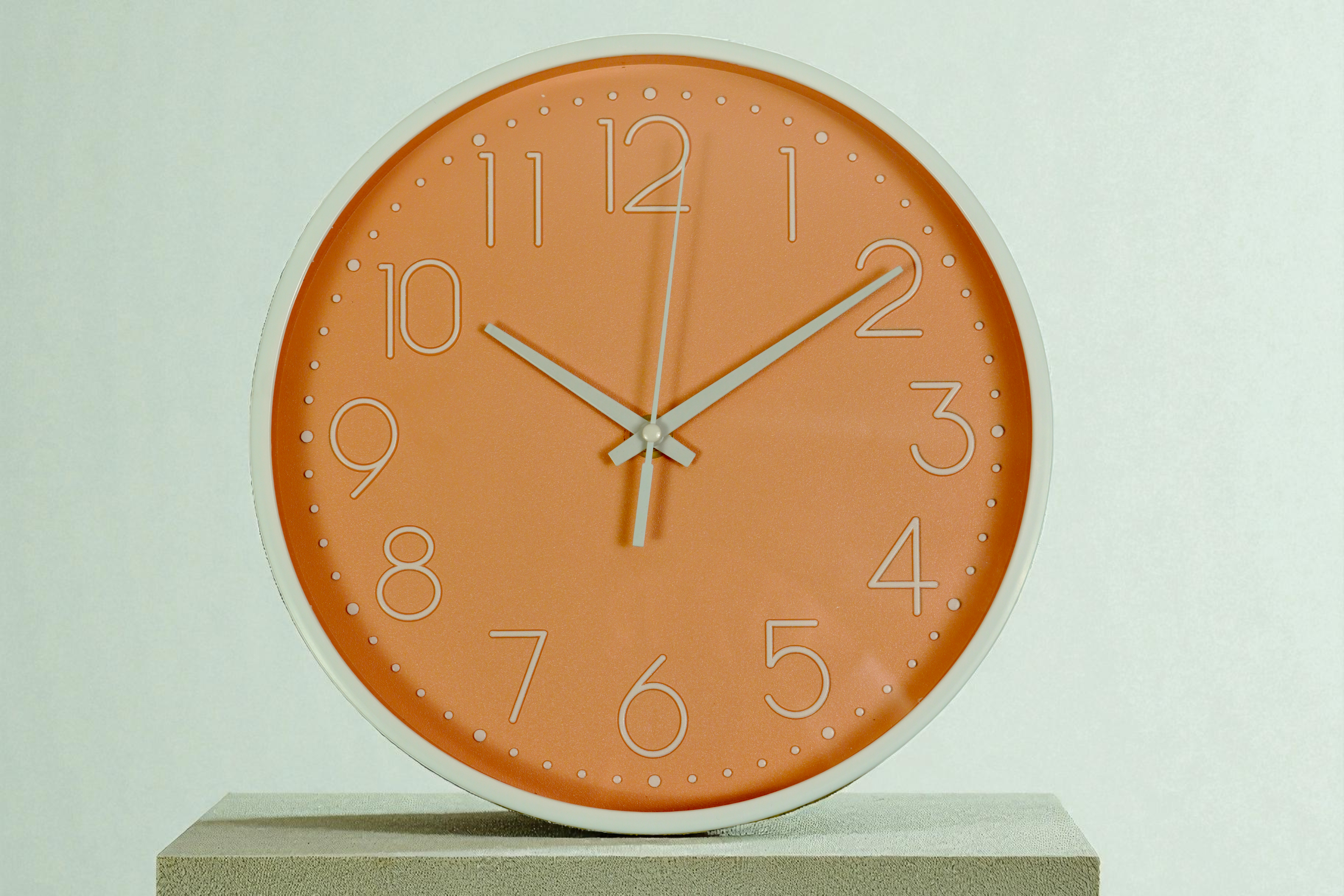 FFO7-11 terracotta wall clock with white numerals, on a pale green wall