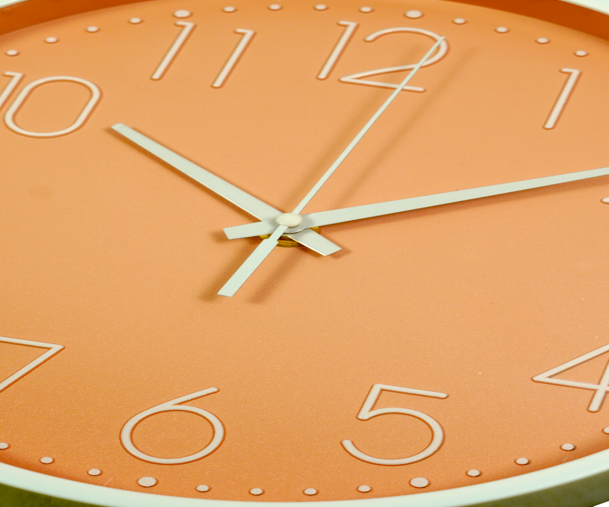 FFO7-11 terracotta wall clock with white numerals, on a pale green wall