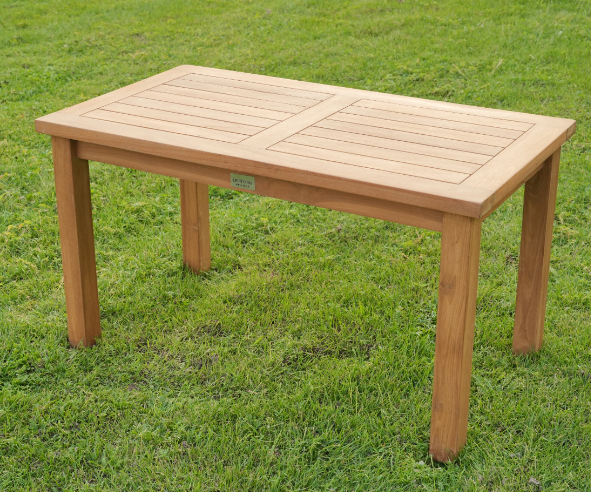 Garden bench straight, teak bench and table on a lawn beside a playground