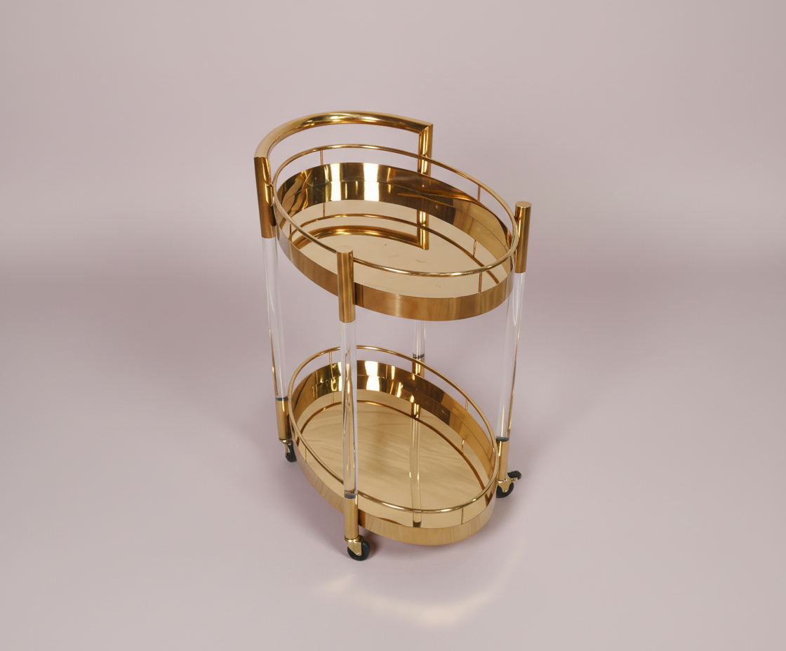 GLASS TROLLEY DC1013, angled view with oval brass shelves and acrylic posts